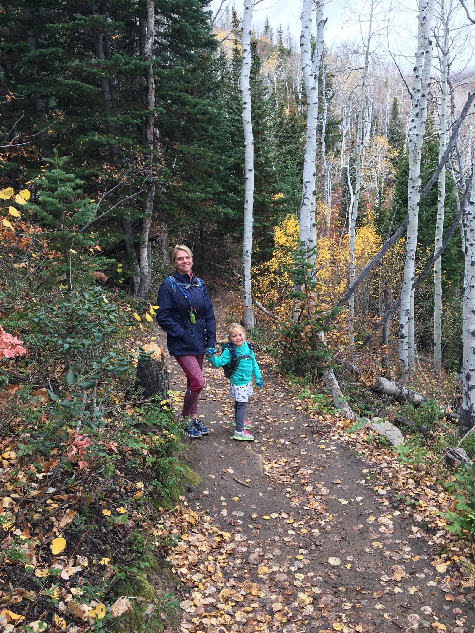 Hikers on Rob's Trail surrounded by golden aspens in fall